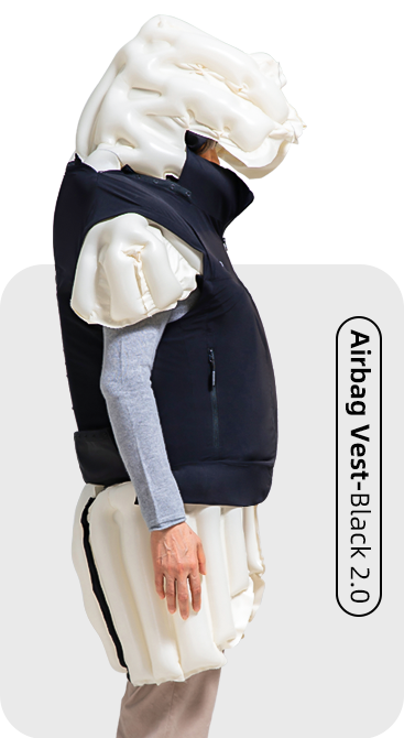 Person wearing a black fall protection airbag vest on a white background